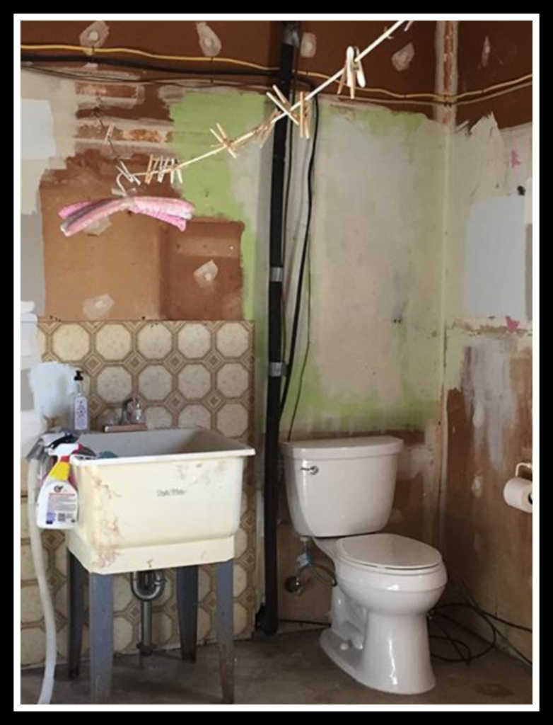 Ugly before photo of laundry room showing sink and toilet area