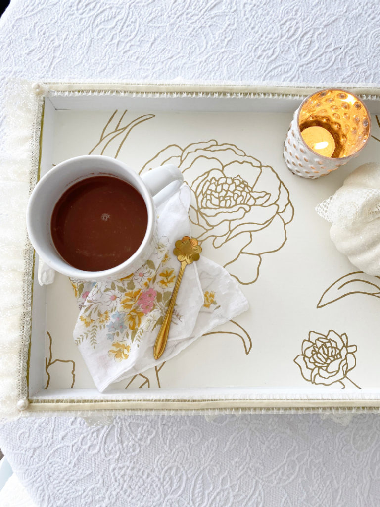 Tray with cocoa, spoon and candle