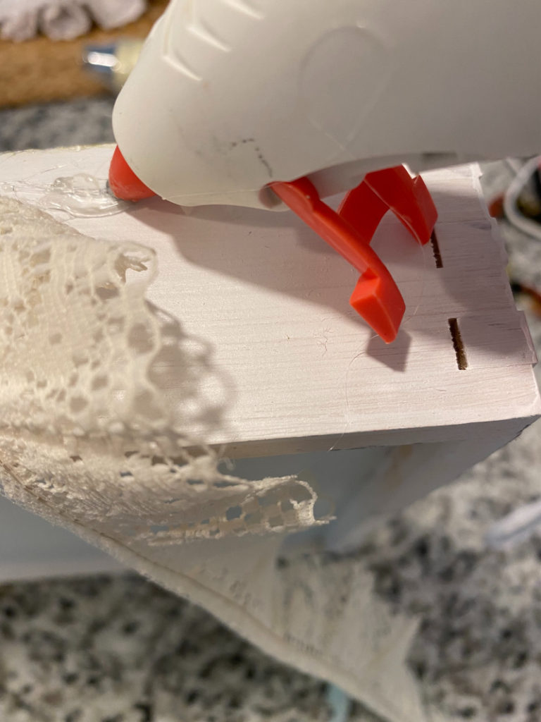 Using glue gun to glue lace on DIY Footed Tray