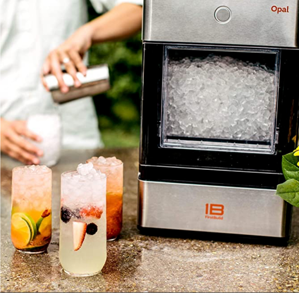 Opal Nugget ice maker on counter with three drinks with fruit and ice