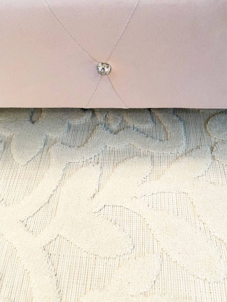 View of pink bed frame and cream sculpted rug for Master bedroom makeover 