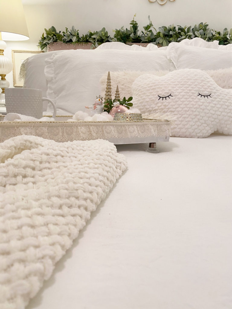 white bed with footed lacy tray with coffee cup and Christmas decor