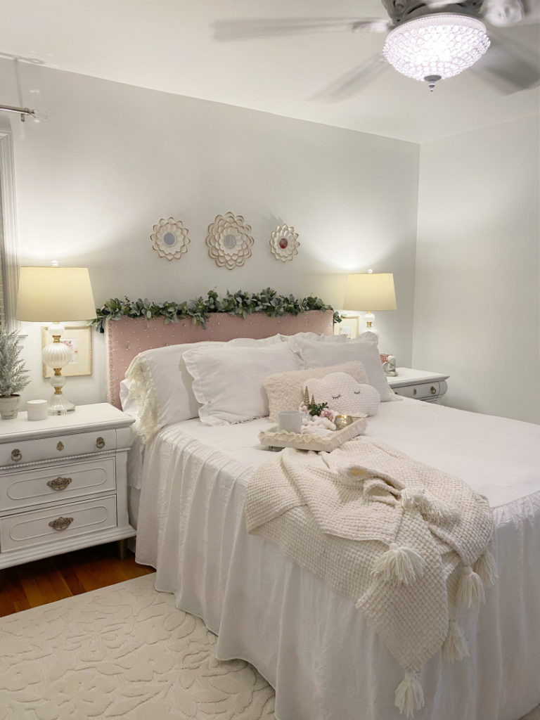 elegant master bedroom with cream tasseled throw blanket on bed