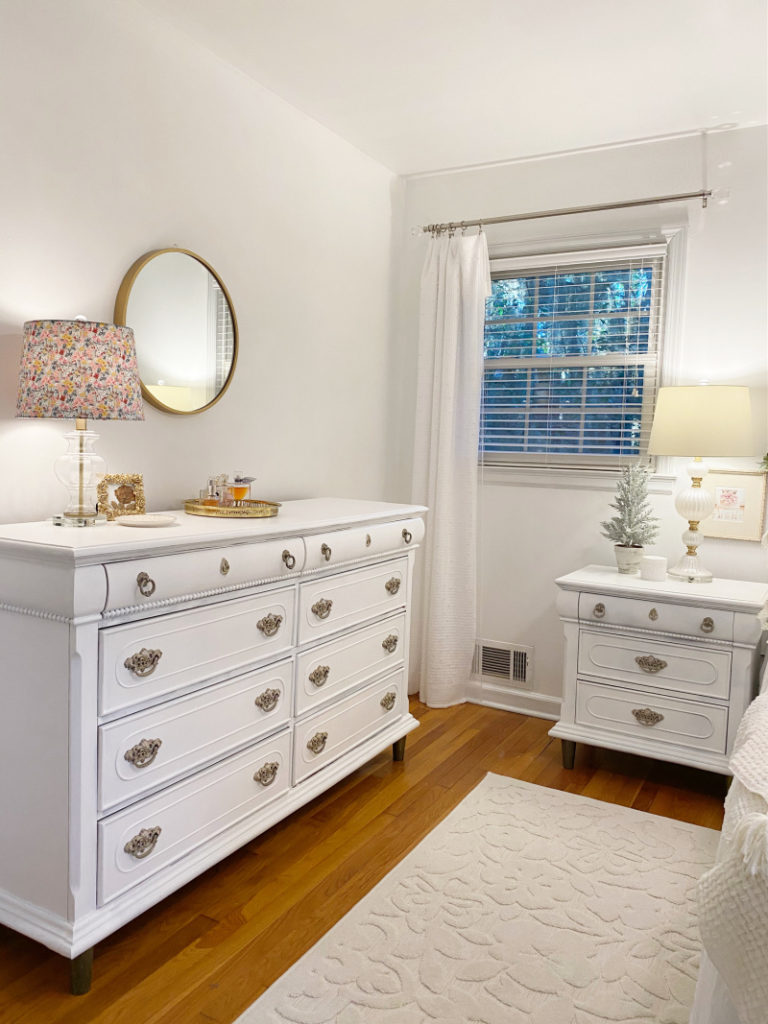 Light filled white painted glamorous master bedroom