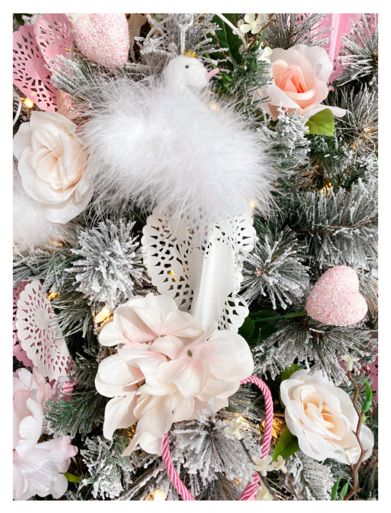 close up of valentine's day tree with fluffy swan with pale pink beak and gold crown