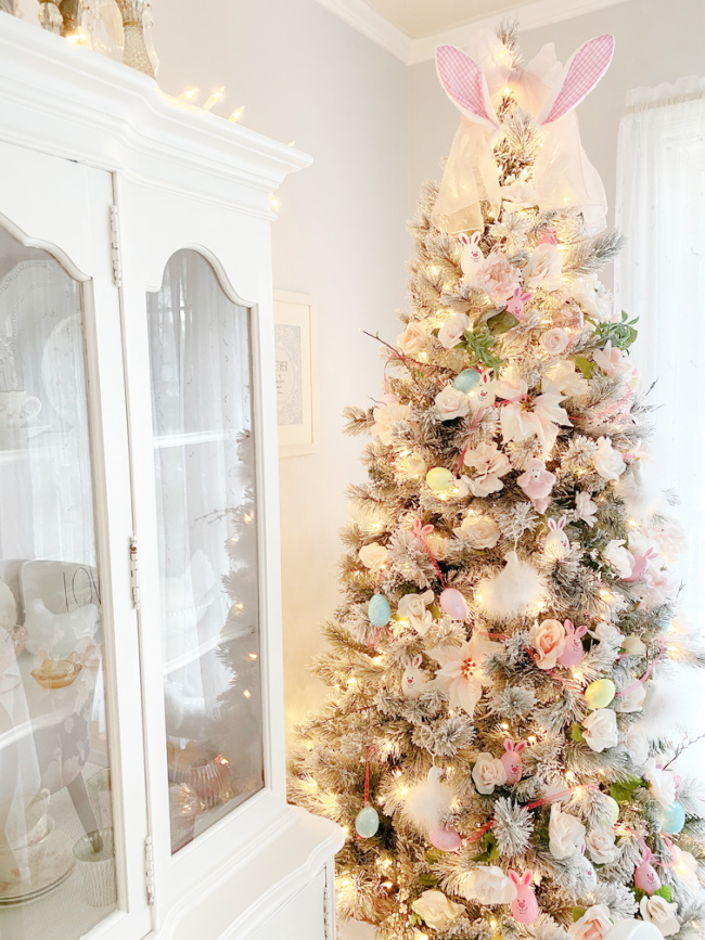 Pastel Easter Tree with lights and vintage white china cabinet in the background