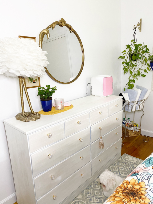 dresser wall with mirror, and flamingo light and pink fridge in guest room makeover