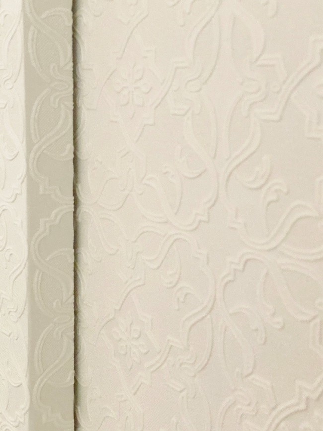 close up of wallpapered sliding closet doors