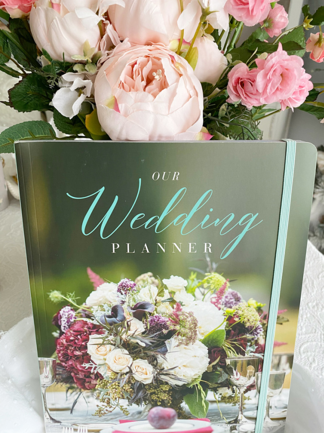 Simple and Sweet Wedding Planner next to Pink Peony flower arrangement