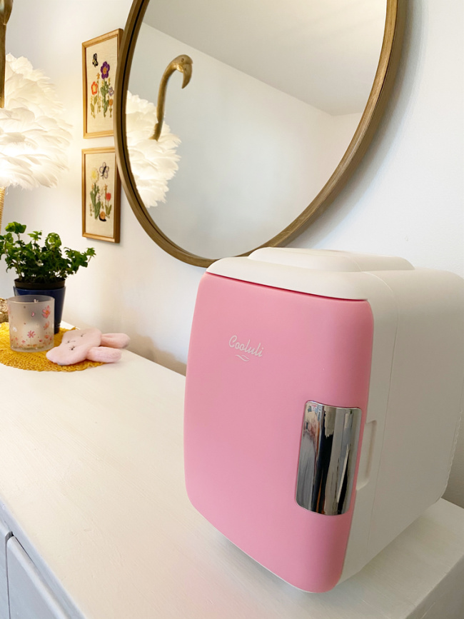 tiny pink fridge on dresser in guest room 