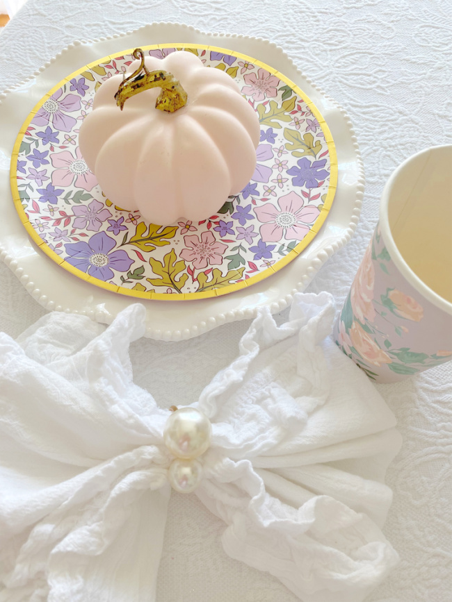 pink pumpkin on floral plate for how to update table setting for fall