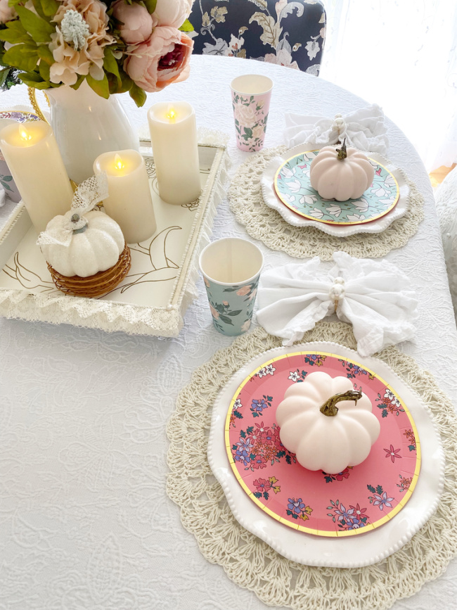 Fall table setting with pink pumpkin and floral plates