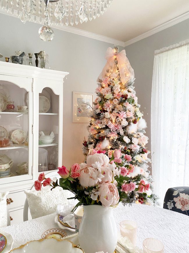 floral may day christmas tree with dining table and china cabinet in view