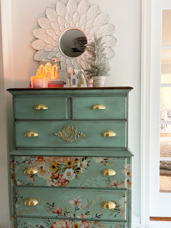Floral dresser in foyer with christmas decor with dining room in vie