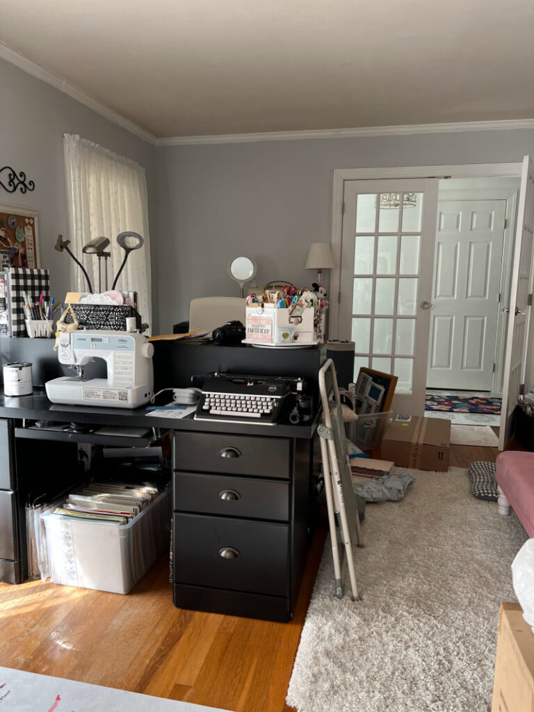 messy black desk, white shag rug, before makeover