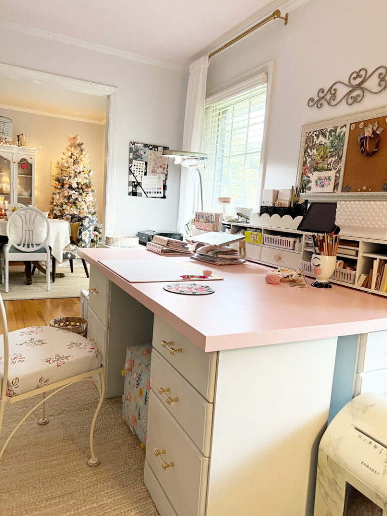 Beautiful pink desk top with white file cabinets underneath - floral accents