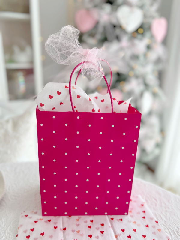 valentine's bright pink gift bag with pink valentines's day tree in background